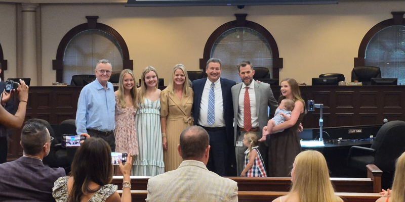 The photo shows City Attorney David Davidson and Assistant Attorney Joseph Cusack being recognized at the City Council Meeting.